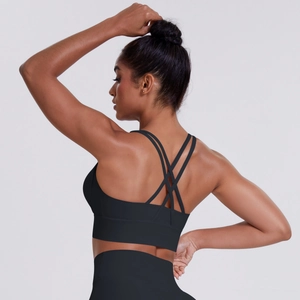 Detail view of black sports bra featuring a cross-strap back design and matching leggings