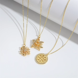 Minimalist gold star and daisy flower pendant necklaces on clean white background