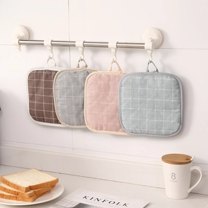 Four colorful checkered cotton pot holders in brown, gray, pink, and blue with hanging loops