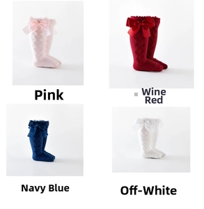 Detail showing cable knit patterns and satin bows on colorful toddler knee high socks