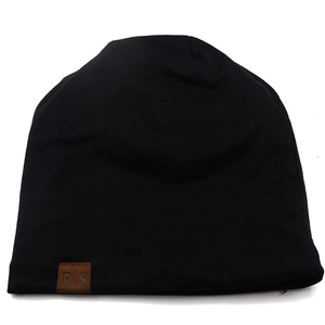 Detail of black breathable knit beanie featuring a brown faux leather F&S logo patch