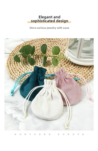 Detail of drawstring velvet jewelry pouches in green, pink, and cream colors
