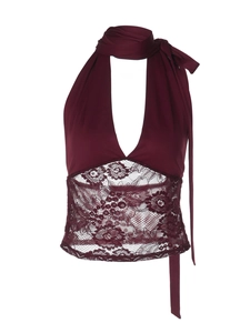 Detailed close-up of burgundy lace patchwork and waist tie on halter neck top