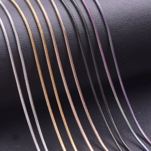 1.2mm stainless steel snake chains in gold, silver and rose gold on dark leather background