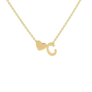 Macro detail of 18k gold plated stainless steel heart necklace featuring letter C charm