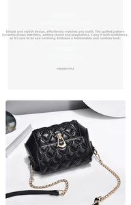 Macro detail of black quilted leather shoulder bag with gold metal buckle closure