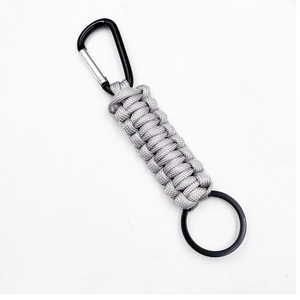 Close-up of grey woven paracord keychain with a black metal carabiner and ring