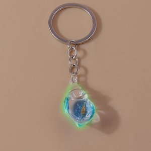Luminous conch keychain with blue glow resin pendant and silver metal ring on pink background
