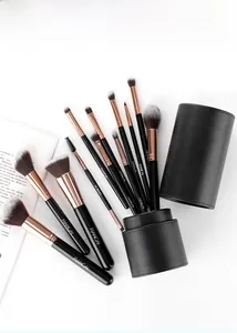 Detailed view of 12-piece black makeup brush set with rose gold ferrules in a PU leather case