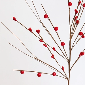 Close-up of vibrant red artificial berry stems for festive Christmas tabletop decoration