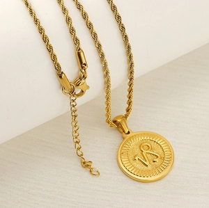 Macro shot of 18k gold plated Capricorn zodiac pendant and textured rope chain necklace