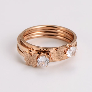 Detail view of rose gold butterfly ring set with crystal zircon stones on white background