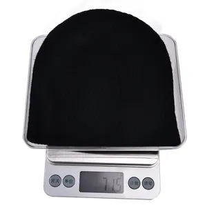 Classic black ribbed knit beanie displayed on a digital scale weighing 71.5 grams