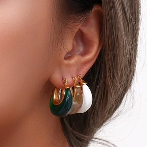 Fashionable thick resin hoop earrings in green, amber, and white with metal clasps