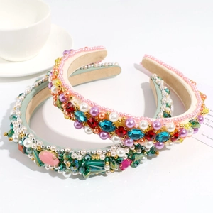 Elegant Baroque style headbands with colorful rhinestones and pearls on a white surface