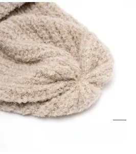 Macro detail of high-quality reinforced stitching on oatmeal knit beanie crown
