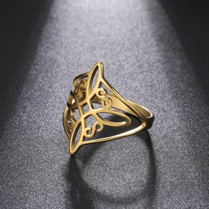 Macro shot of gold Celtic knot ring showcasing intricate hollow geometric metalwork details