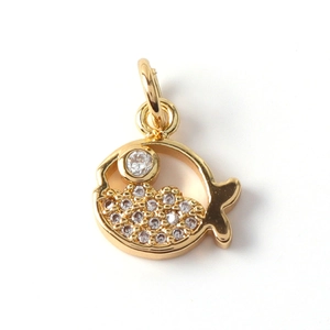 Close-up of a gold-plated fish pendant with sparkling cubic zirconia inlay