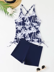 Detailed flat lay of navy tankini swimwear with palm tree print and side drawstrings