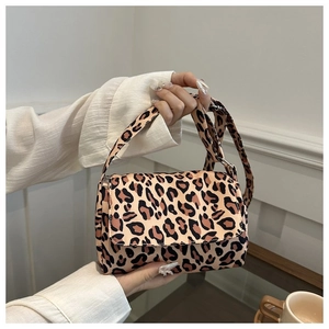 Detail shot of leopard print mini flap crossbody bag with matching wide shoulder strap