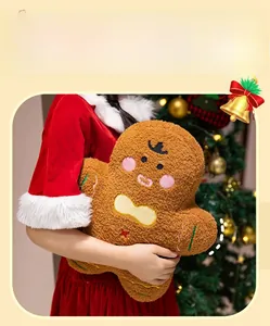 Detailed plush texture of a gingerbread man toy held in a cozy Christmas setting