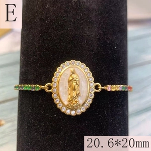 Macro shot of Virgin Mary religious charm with colorful zircon stones and gold finish