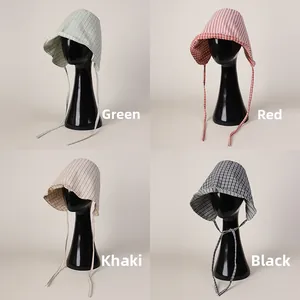 Collage of reversible plaid baby bonnets with adjustable ties in four different patterns