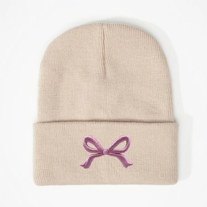 Beige knitted beanie hat with purple embroidered bow design in trendy Korean style