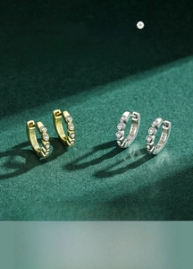 Macro shot of S925 sterling silver hoop earrings with inset turquoise and white zircons