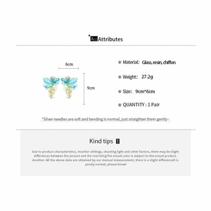 Detailed view of light blue butterfly earrings made of glass resin and chiffon fabric