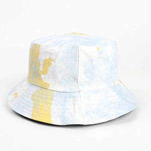 Close-up of yellow and blue tie-dye bucket hat showing canvas texture and stitching
