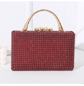 Detail of red rhinestone evening bag with elegant golden bamboo metal handle