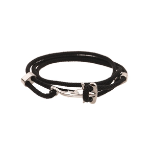 Detail of black nautical rope bracelet featuring a silver anchor-shaped metal fastener