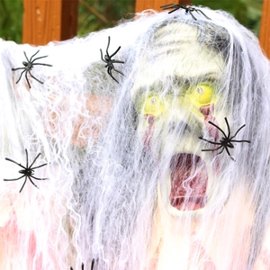 Glow-eyed Halloween skull prop with blood tears and tangled spider web decoration