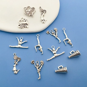 Detailed view of silver cheerleading charms and cheer leader megaphones on a blue backdrop