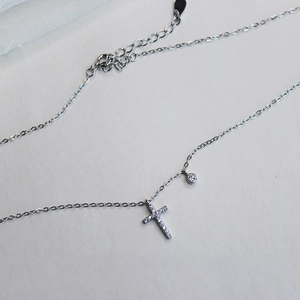 Detail of silver S925 sterling silver cross pendant necklace with sparkling zircon stones