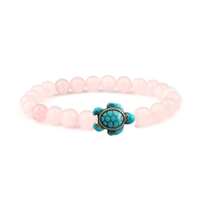 Detailed view of pink crystal beads bracelet featuring a turquoise sea turtle charm pendant