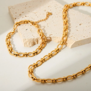 Golden stainless steel necklace and bracelet set with twisted textured chain links