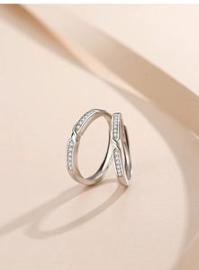 Macro shot of S925 sterling silver couple rings with sparkling pavé cubic zirconia inlay