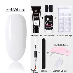 Detail of professional nail extension kit with white gel, UV lamp and manicure tools
