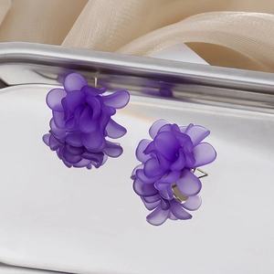 Detail of purple matte flower earrings in 925 silver on silver metal tray