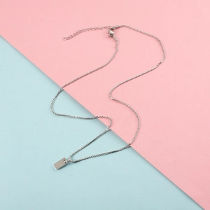 Minimalist silver stainless steel square pendant necklace with venetian chain on pastel backdrop