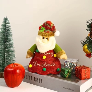 Detail of plush Santa figurine with Merry Christmas embroidery for holiday gift decor
