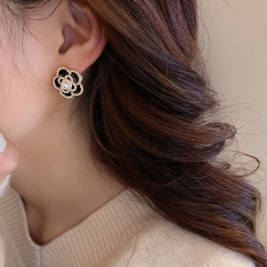 Vintage camellia flower stud earrings with black enamel petals and faux pearl center