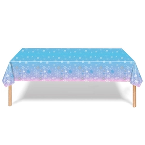 Close-up of blue and pink gradient Christmas tablecloth with white snowflake patterns