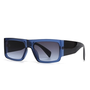 Modern square sunglasses with blue transparent frames and gradient grey lenses on white