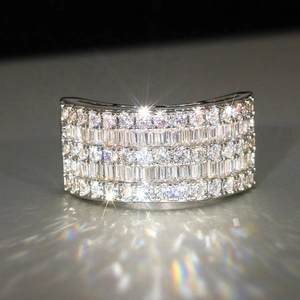Macro shot of silver wide ring with rows of sparkling pavé-set zircons for women