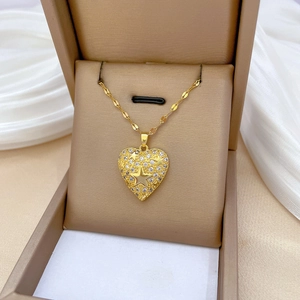 Elegant gold heart pendant necklace with star zircon inlay in a premium jewelry box