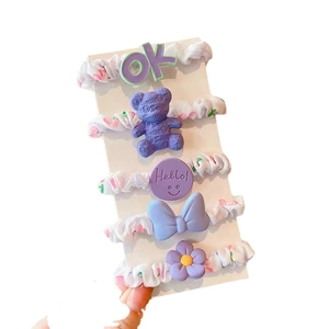 Purple 5-piece kids hair scrunchie set with bear and bow designs on display card