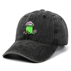 Detail of embroidered green frog and mushroom on washed charcoal grey baseball cap